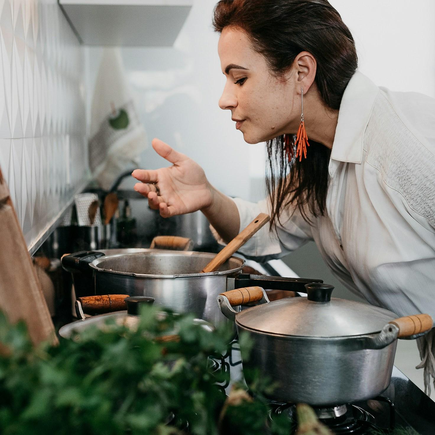 Members collaborating in a contemporary kitchen, exchanging recipes and cooking techniques